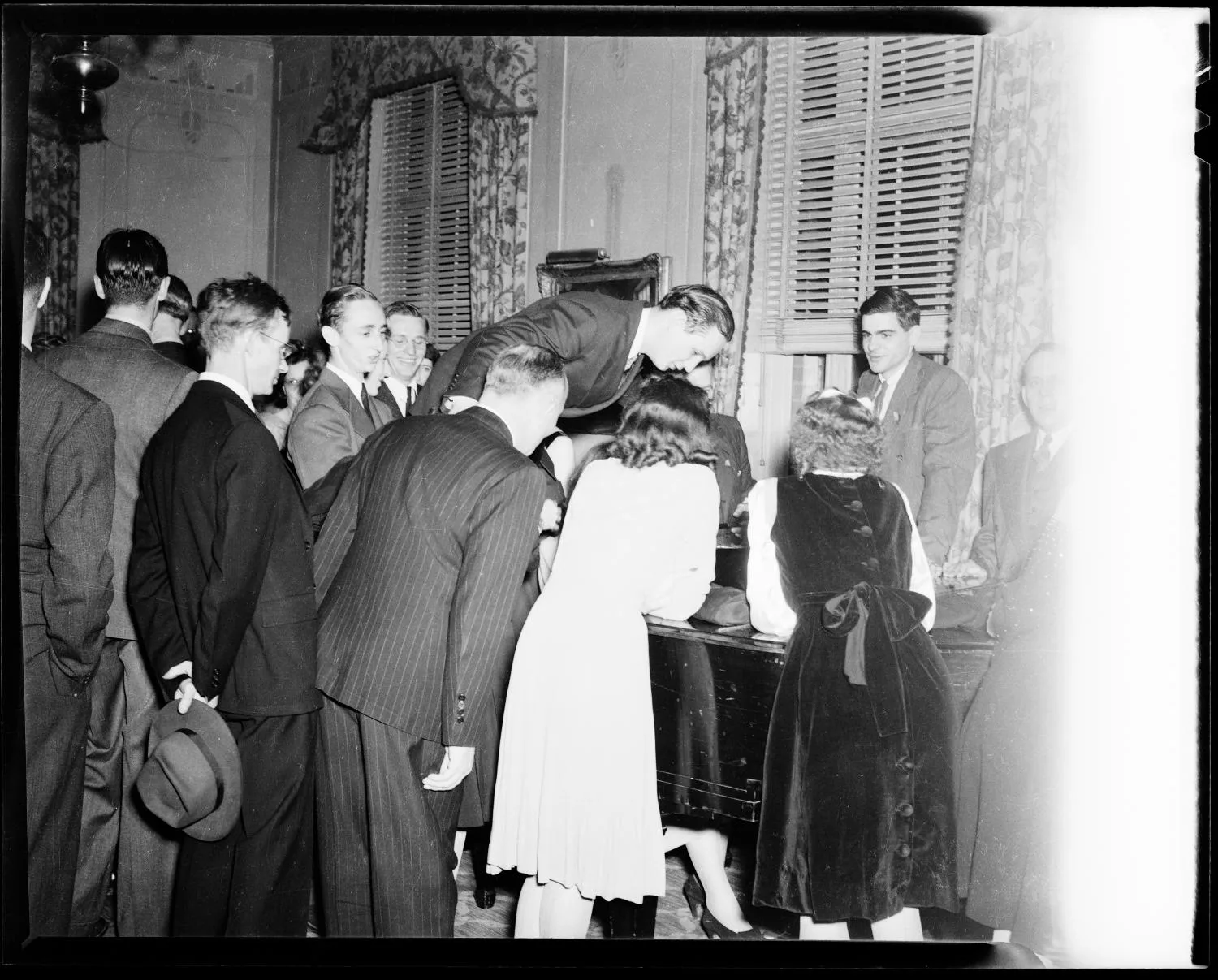 People Grouped Around Piano