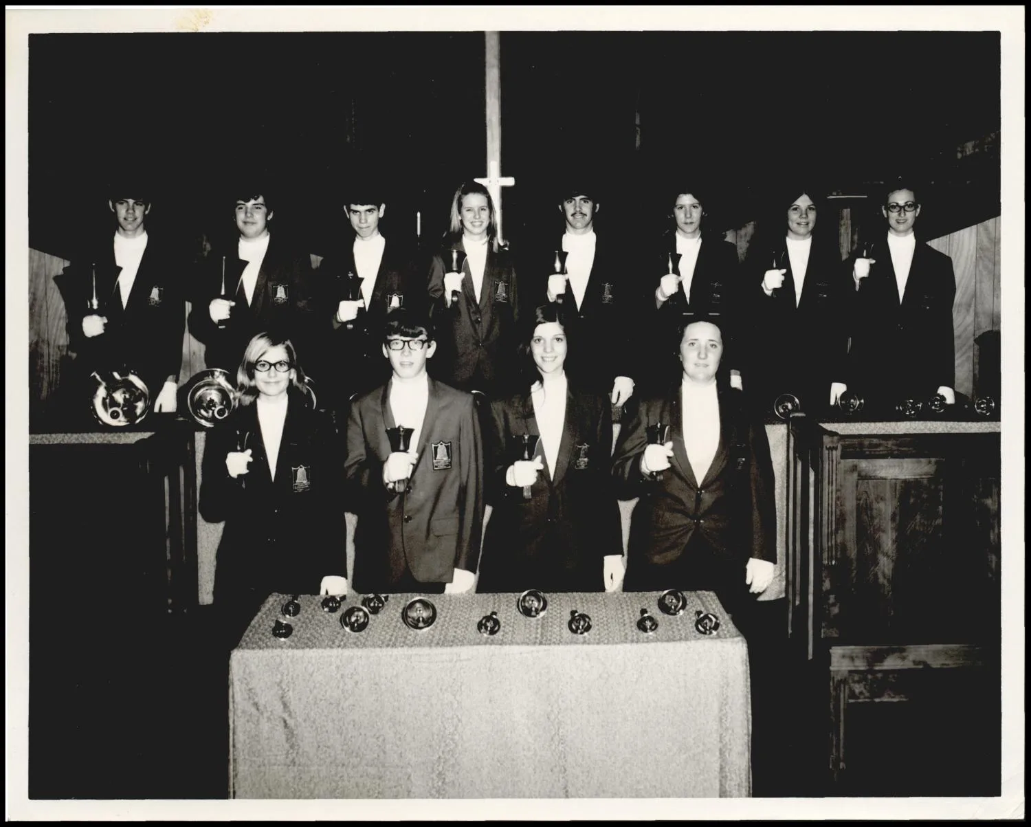 Photograph taken for a newspaper owned by the Oklahoma Publishing Company. Caption: "The Bartlesville Handbell Choir II, directed by W. D. McKeehan, will be a guest organization at the 39th Tri-State Music Festival in Enid this week, presenting programs in conjunction with the matinee and evening Grand concerts Saturday."