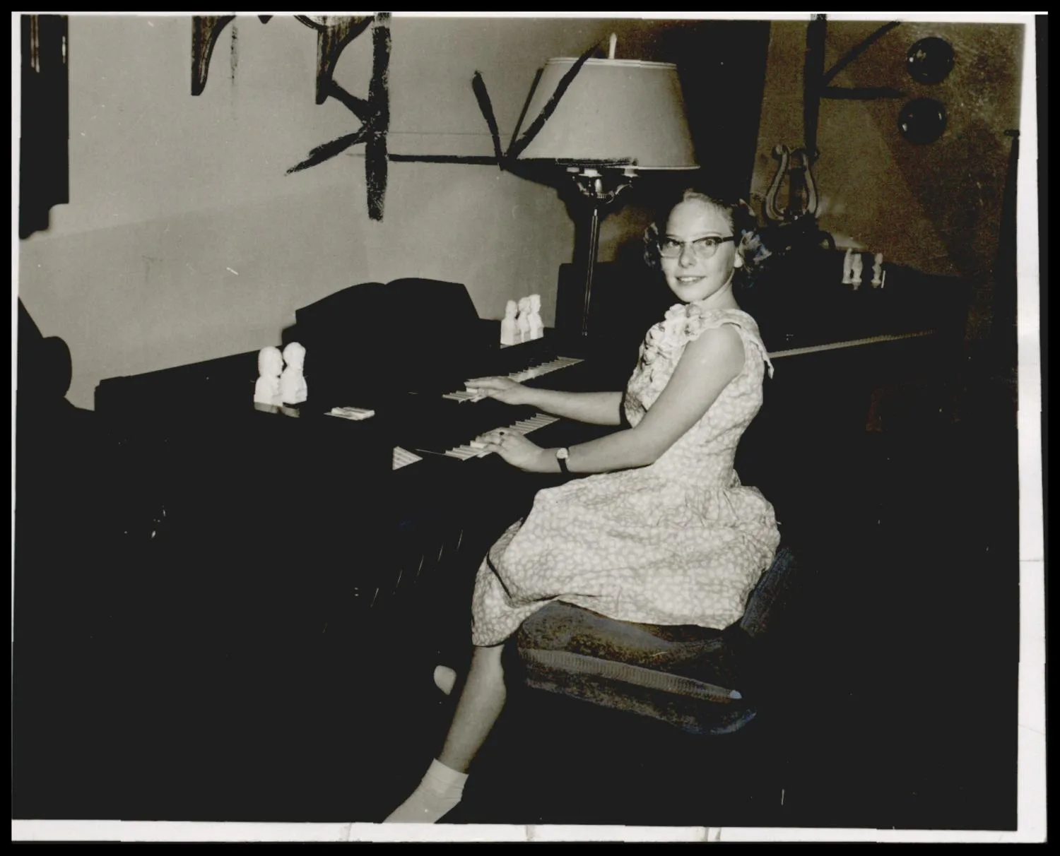 Photograph taken for a story in the Oklahoma Times newspaper. Caption: "For being a national winner 10 years in International Piano Guild competition was Patricia Fisher, daughter of Mr. and Mrs. Billy Fisher, Frederick , and a freshman in Frederick High School."