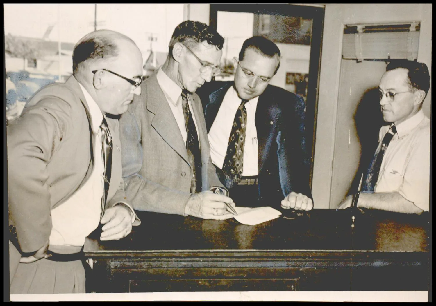 Photograph used for a story in the Oklahoma Times newspaper. Caption: "Officers of the Madill Band Parents' Club are (left to right) Aubrey Paregien, vice president; E. J. Bolin, president; Rev. Walter Browers, treasurer; and Virgil Johnson, secretary."