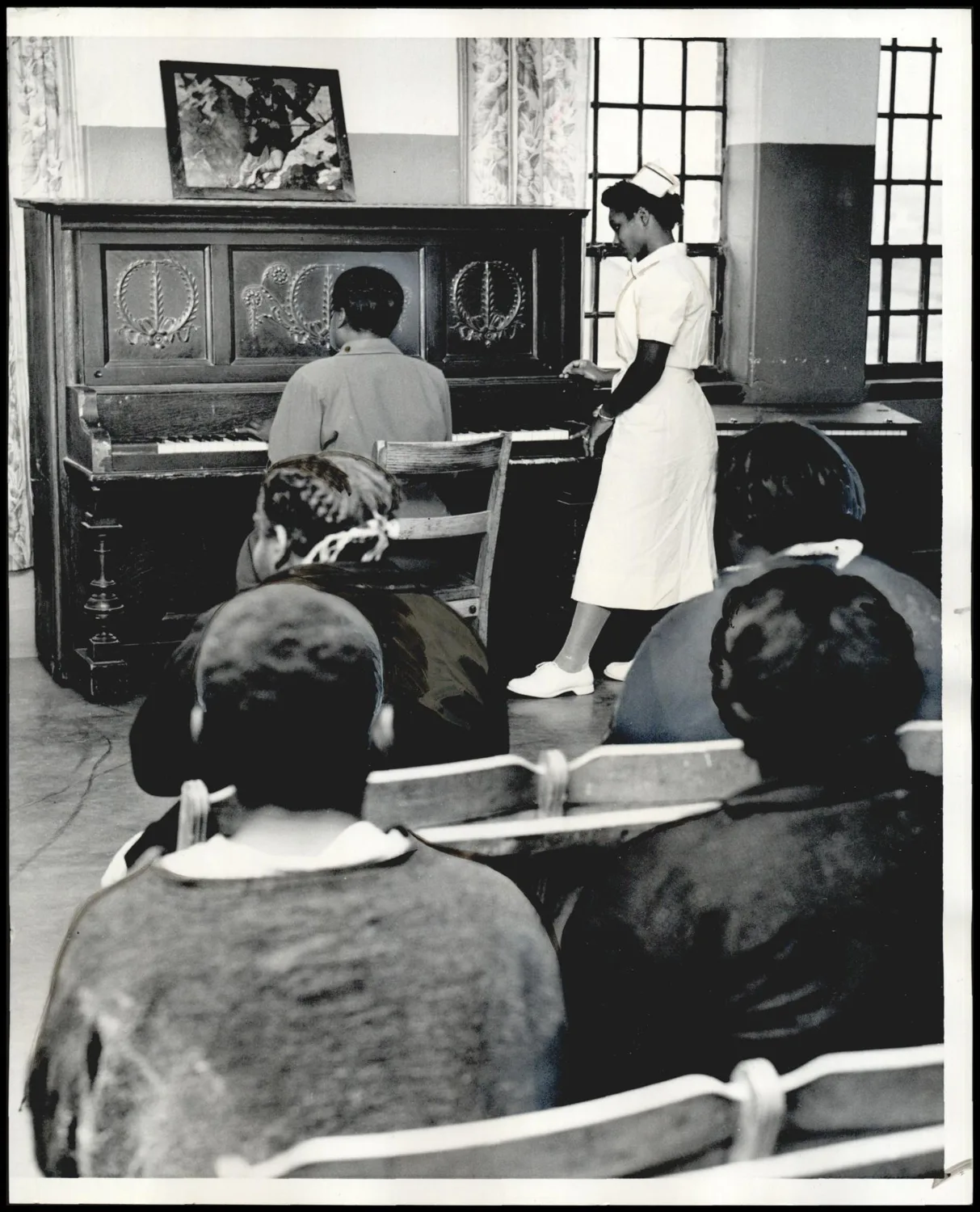 Photograph used for a story in the Oklahoma Times newspaper. Caption: "The patient at the piano is a talented musician."