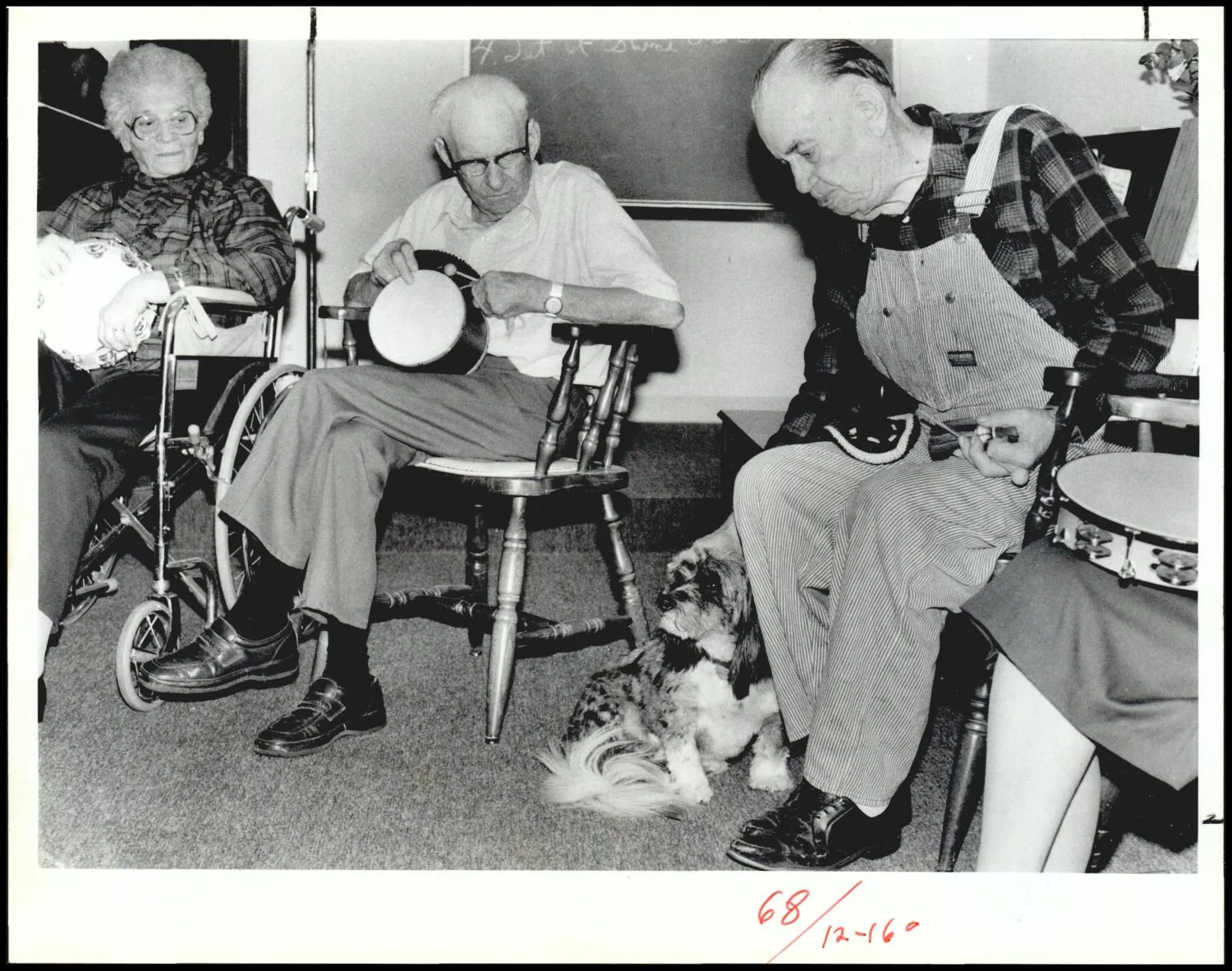Photograph used for a story in the Daily Oklahoman newspaper. Caption: "Members of the nursing homes rhythm band, from left, Roy Webber and Bennie Huckleberry enjoy Samantha's company."