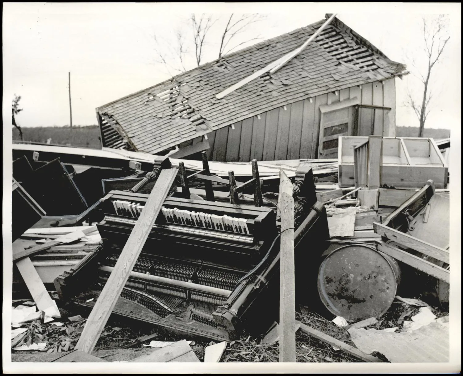 Photograph used for a story in the Daily Oklahoman newspaper. Caption: "An over turned piano lay in the wreckage of the Bowlegs Methodist church after tornadic wins swept through the town Monday morning."