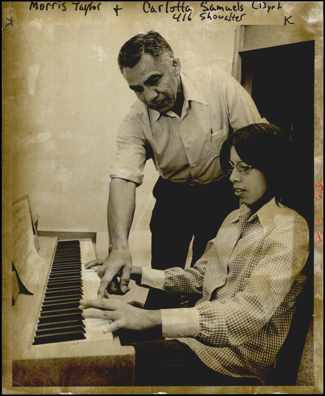 Photograph used for a story in the Daily Oklahoman newspaper. Caption: "An unusual type of volunteer is Morris Taylor, Ardmore, who is giving four weeks of his time to teach members of Angie Smith Indian Methodist Church, 401 SW 31, the basics of piano."