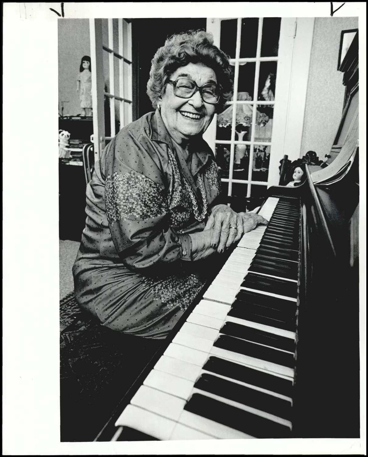 Photograph used for a story in the Daily Oklahoman newspaper. Caption: "Verna Kellogg West.. . remembering her piano-playing days Verns Kellogg West in her home in Guthrie where she has lived since 1911."