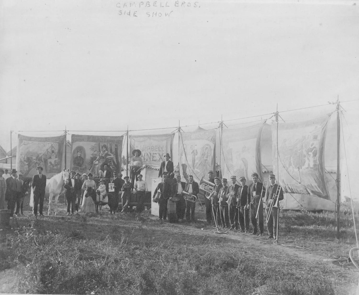 Campbell Brothers Circus troupe and side show banners. A band and other performers, DeBarcsy family, Little Nick. Count Nicu DeBarscy, who traveled with his mother, Madam DeBarcsy, the bearded lady, and his stepfather, the Indian Medicine Man.